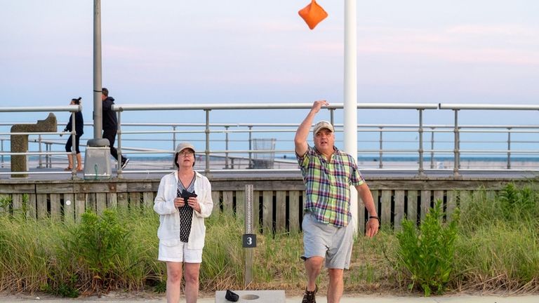 Kevin and Susan Reilly, of Glen Head, play cornhole at...