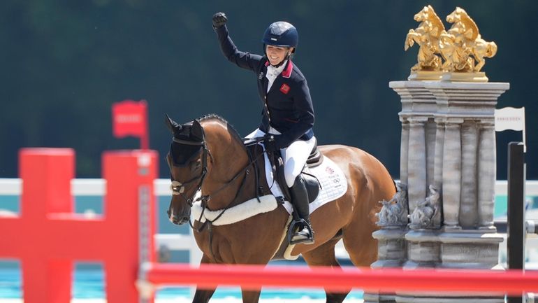 Britain's Laura Collett, riding London 52, celebrates after winning the...