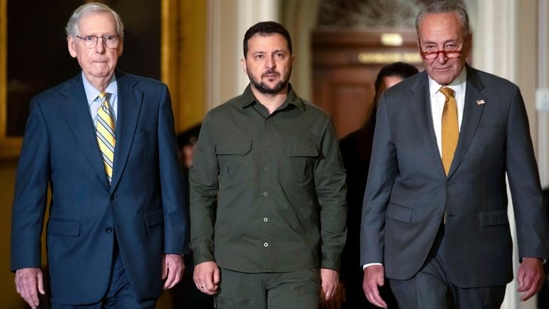 Ukrainian President Volodymyr Zelenskyy, center, walks with Senate Minority Leader...