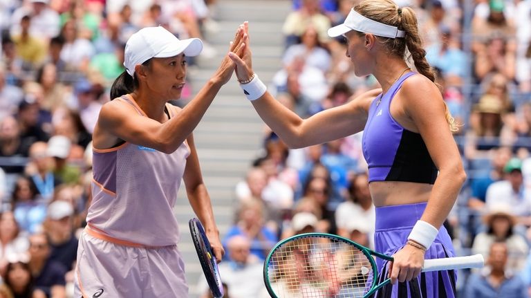 Kristina Mladenovic, of France, and Zhang Shuai, of China, high...