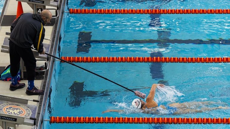 Paralympian Anastasia Pagonis is tapped on the head by her...