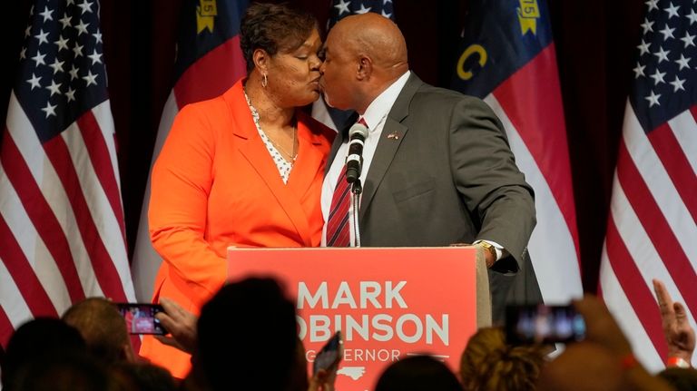 North Carolina Lt. Gov. Mark Robinson, right, Republican candidate for...