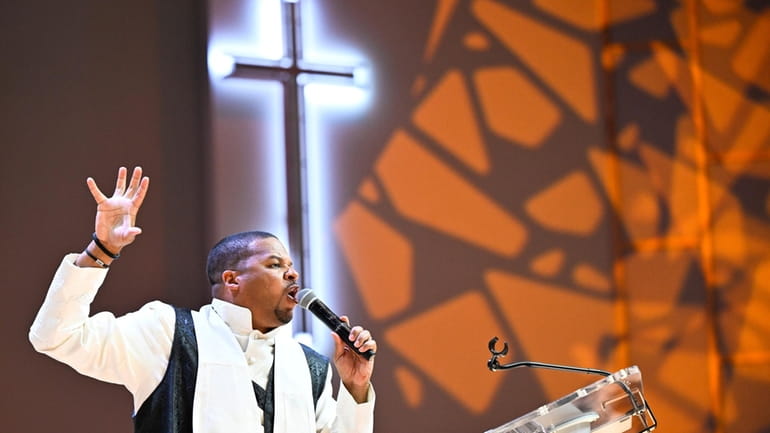 Reverend Matthew L. Watley delivers his sermon during Sunday service...