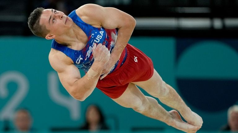 Paul Juda, of United States, competes on the floor exercise...