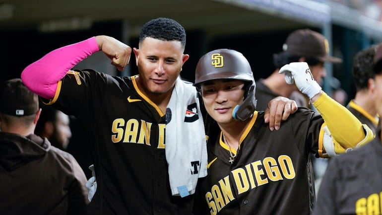 San Diego Padres' Ha-Seong Kim (7) and Fernando Tatis Jr