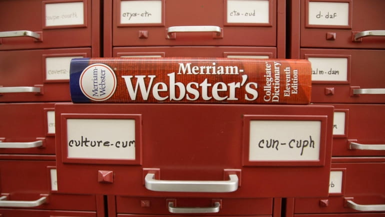 A Merriam-Webster dictionary sits atop their citation files at the...