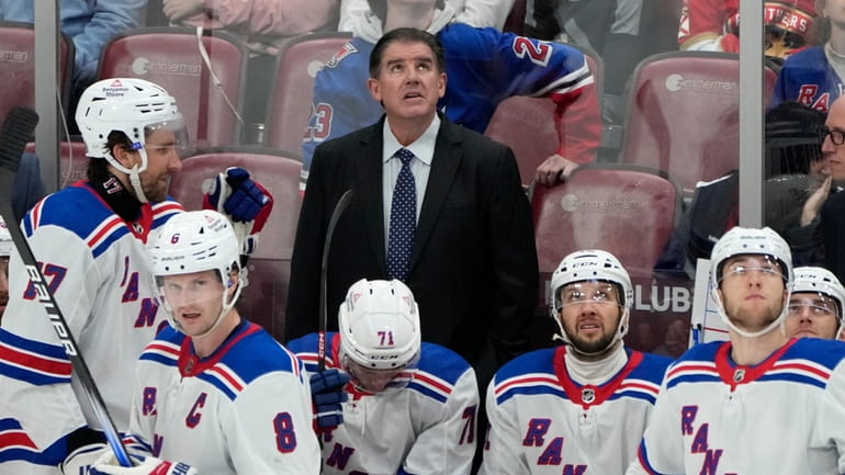 Rangers coach Peter Laviolette, top center, watches a replay review...