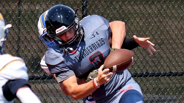 Half Hollow Hills East QB Jordan Heyman gets sacked in...