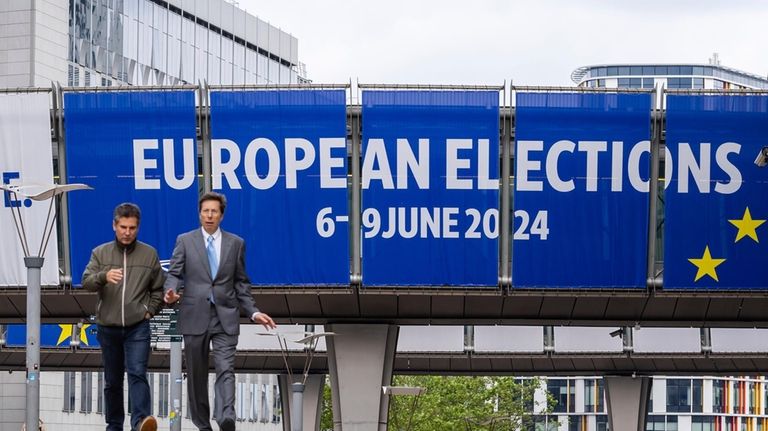 People walk outside the European Parliament prior to a debate...