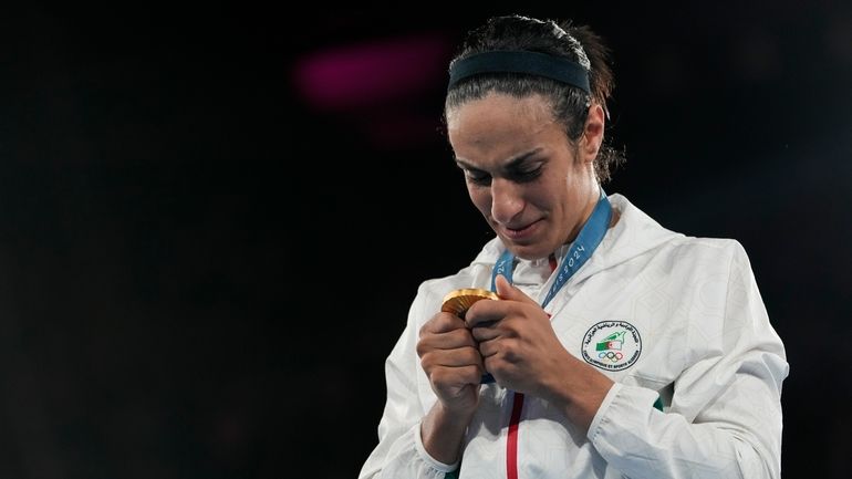 Gold medalist Algeria's Imane Khelif attends a medals ceremony for...