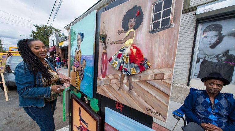 Louisa Conner Griffin with her colorful artwork on Sunday at the arts fair in...