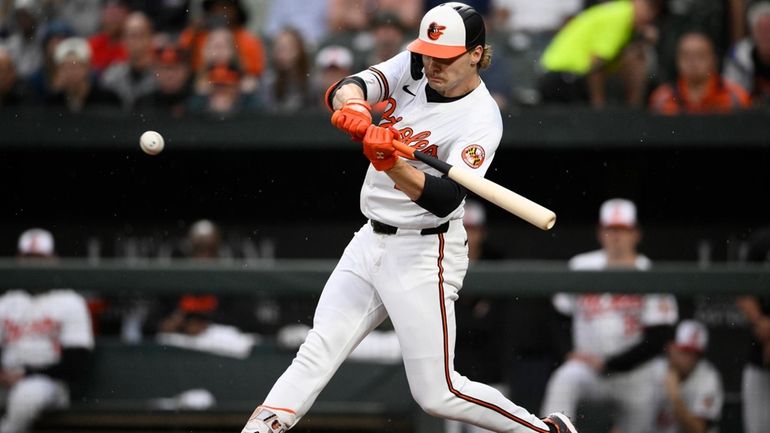 Baltimore Orioles' Gunnar Henderson swings for a grand slam against...