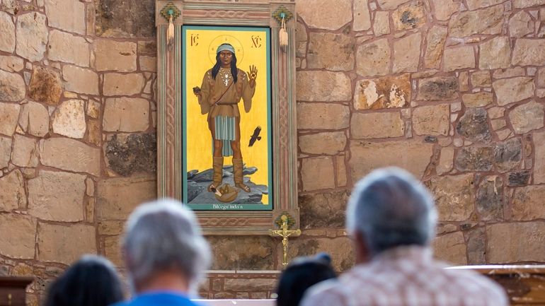 The Apache Christ painting hangs behind the altar of St....