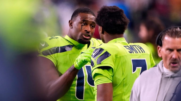 Seattle Seahawks wide receiver DK Metcalf (14) talks with quarterback...