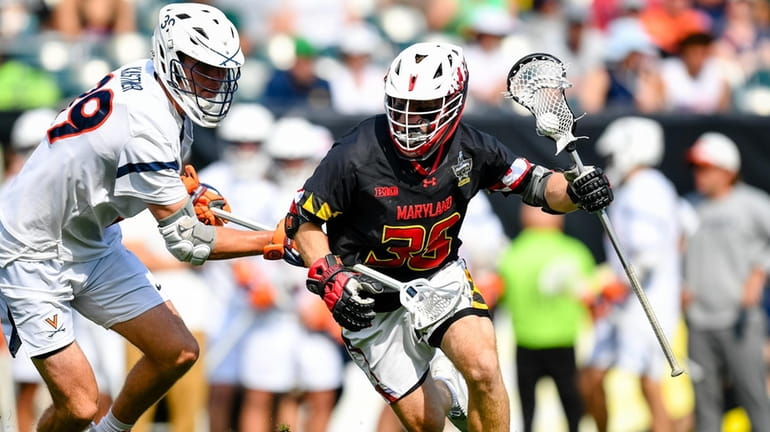 Midfielder Kevin Tucker (35) on the move for Maryland against...