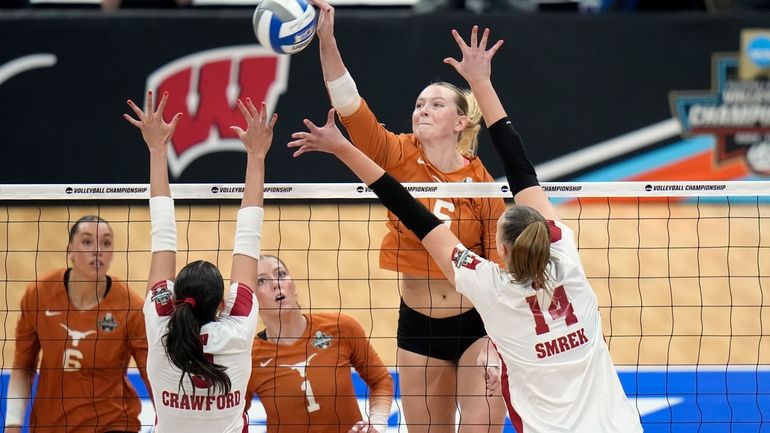 Texas's Bella Bergmark (5) scores over Wisconsin's Caroline Crawford (9)...