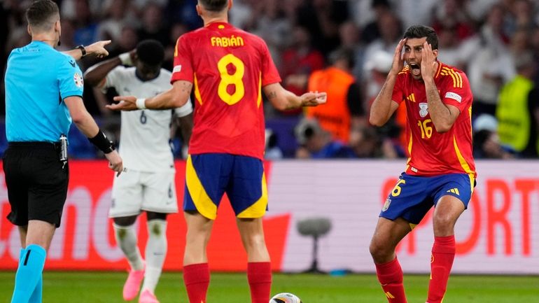 Spain's Rodri, right, reacts to a referee decision during the...