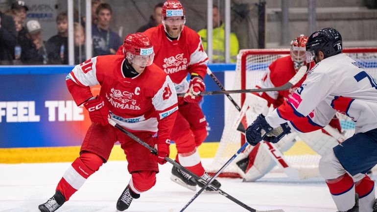 Denmark's Lars Ellers, left, faces England's Robert Dowd during the...