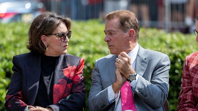 Former Alabama football head coach Nick Saban, right, talks with...