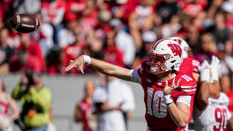 Wisconsin quarterback Tyler Van Dyke (10) passes against South Dakota...