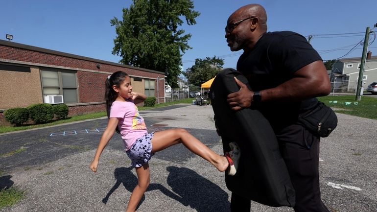 Juliana Montenegro learns self-defense moves from Darren Drain at the Parent Resource...