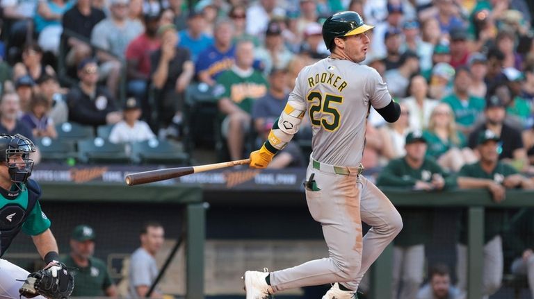 Oakland Athletics' Brent Rooker (25) follows through on an RBI...