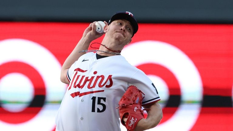 Minnesota Twins relief pitcher Emilio Pagan throws in the fifth...