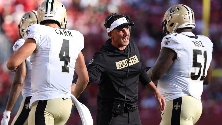 New Orleans Saints head coach Dennis Allen, middle, celebrates with...