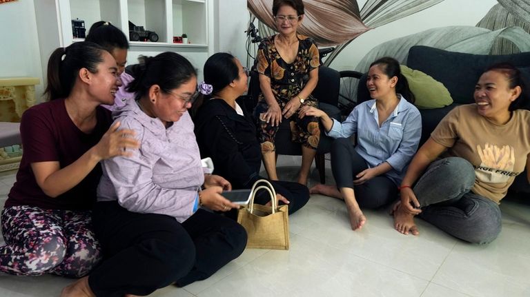 Chhim Sithar, second from right, president of the Labor Rights...