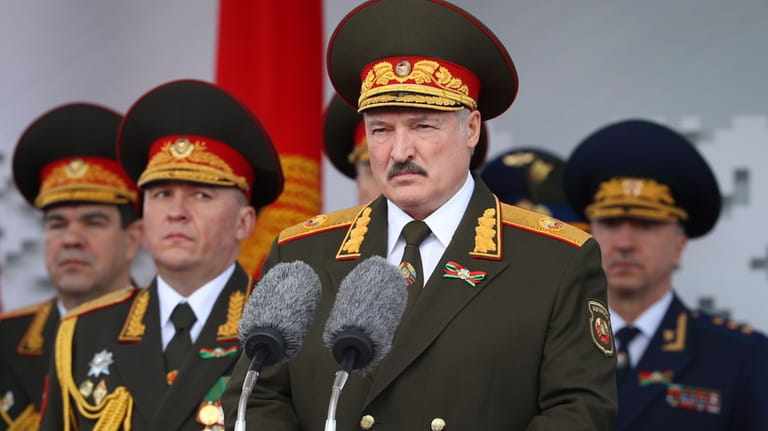 Belarusian President Alexander Lukashenko, center, gives a speech during a...