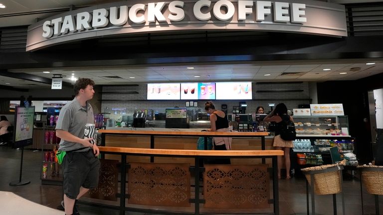 A patron walks out of a Starbucks at Phoenix Sky...