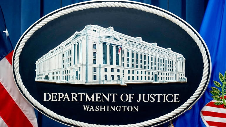 The U.S. Justice Department sign is seen, Nov. 18, 2022,...