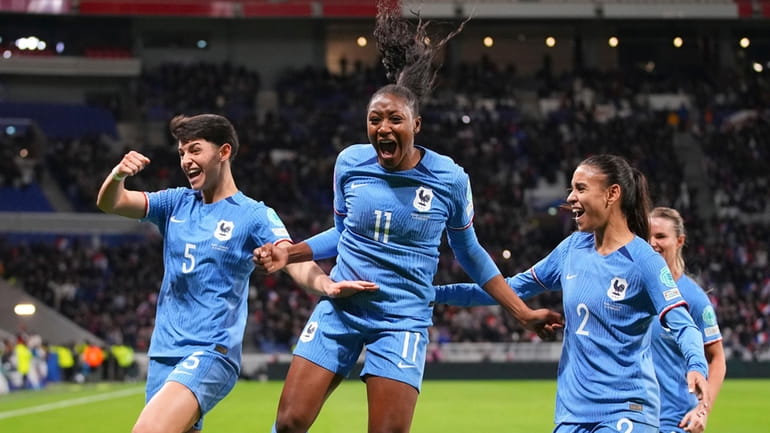 France's Kadidiatou Diani, centre, celebrates with teammates after scoring her...