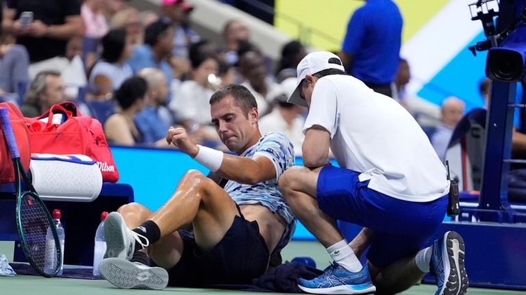 Laslo Djere, of Serbia, is examined during a second round...