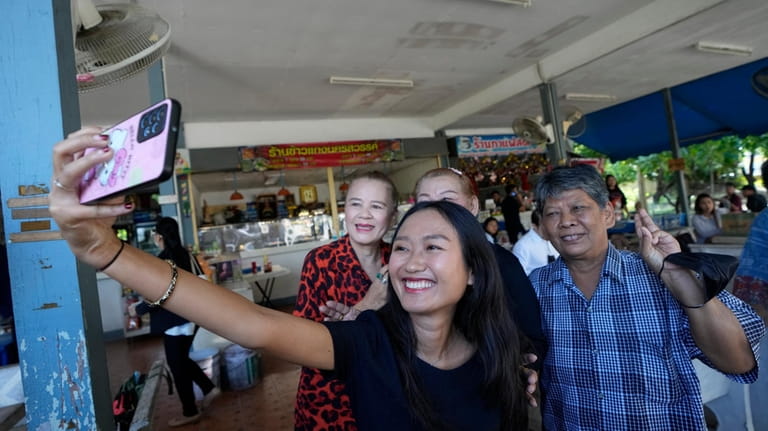 Move Forward Party's Chonthicha Jangrew, front, takes a selfie with...
