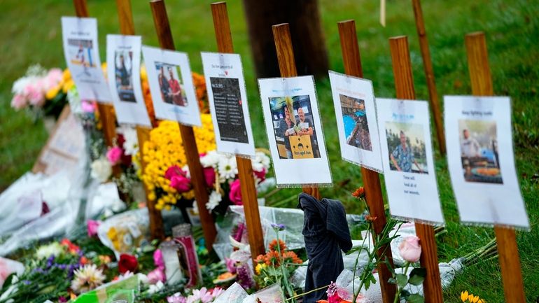 Rain soaked memorials for those who died in a mass...