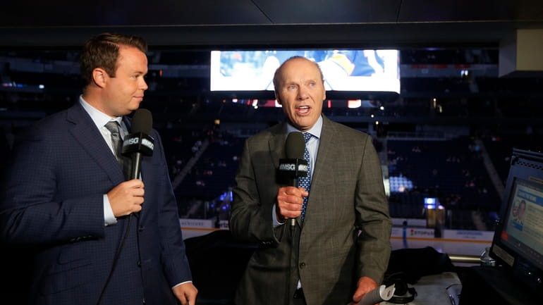 New York Islanders broadcasters Brendan Burke and Butch Goring work a...