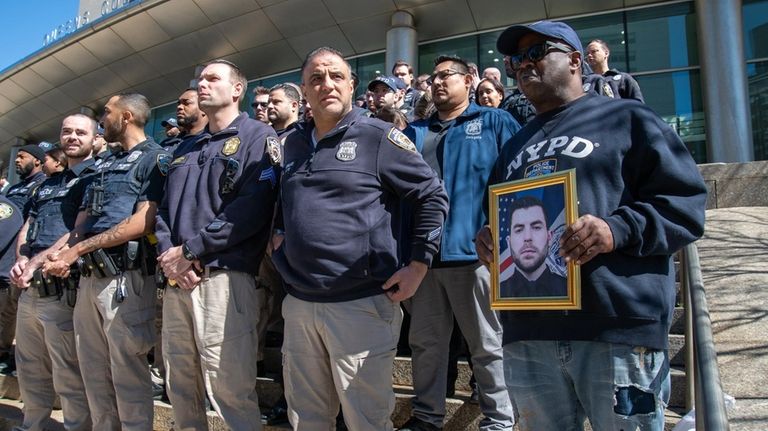 Members of the NYPD and others outside Queens Criminal Court on...