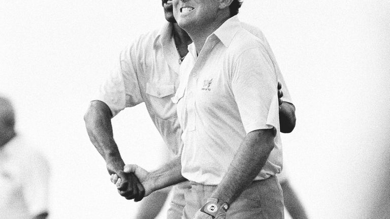 U.S. golfer Calvin Peete congratulates Lanny Wadkins after his shot...