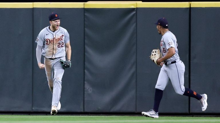 Detroit Tigers center fielder Parker Meadows, left, reacts with right...