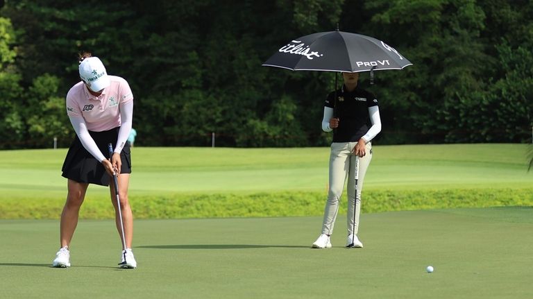 Minjee Lee of Australia plays a putt on the 11th...