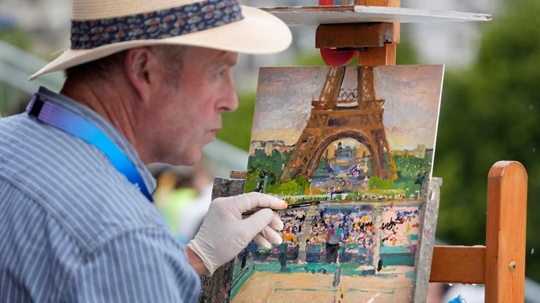 Peter Spens, of London, England, paints the scene at Eiffel...