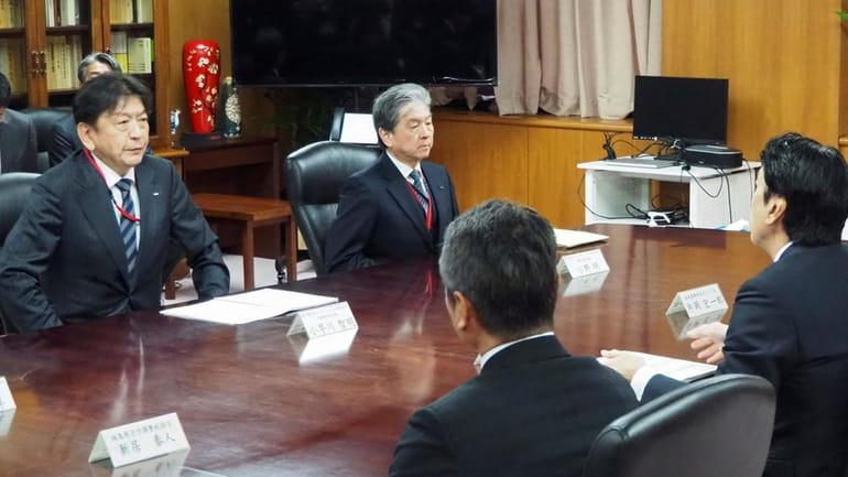 Tokyo Electric Power Company Holdings (TEPCO) President Tomoaki Kobayakawa, left,...