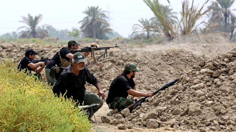 Iraq Shiite fighters prepare to fight militants from the extremist...