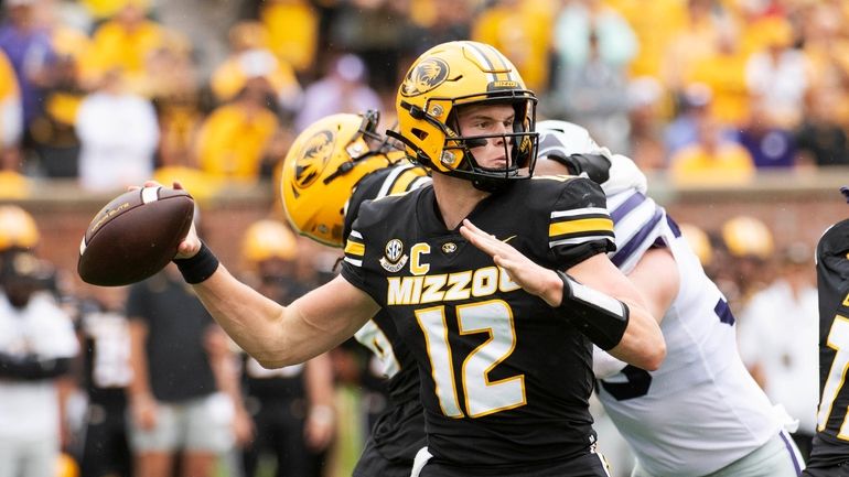 Missouri quarterback Brady Cook throws a pass during the first...