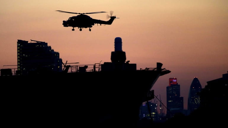 A helicopter lands on the Royal Navy's largest warship, the...