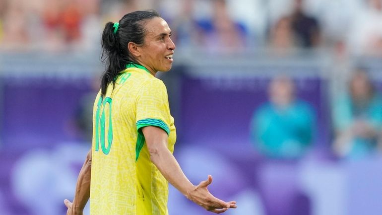 Brazil's Marta leaves the pitch after being shown a red...