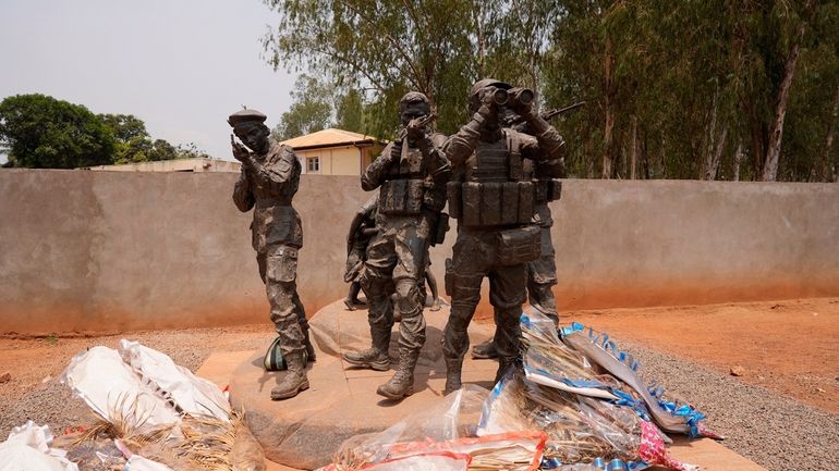 Flowers are laid at the statue of Russian mercenaries as...