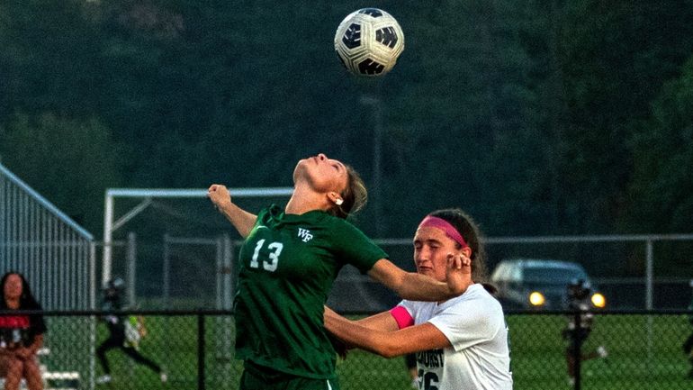 Floyd's Kayla Gilmore (#13) and Lindenhurst's Jessica Zielinski (#26) go...