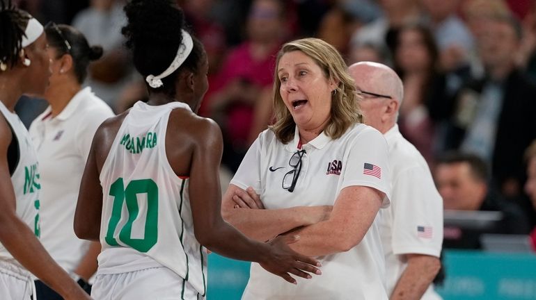 United States' Cheryl Reeve talks with Promise Amukamara (10), of...